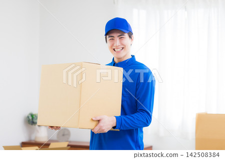 Worker with cardboard box Worker with cardboard box 142508384