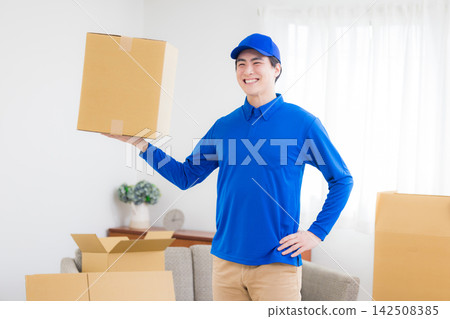 Worker with cardboard box Worker with cardboard box 142508385