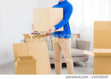Worker with cardboard box Worker with cardboard box 142508387