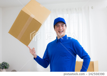 Worker with cardboard box Worker with cardboard box 142508390