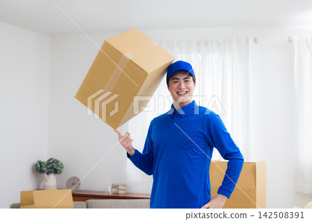 Worker with cardboard box Worker with cardboard box 142508391