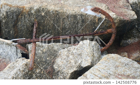 Old Rusty Anchor Resting on Coastal Rocks Old Rusty Anchor Resting on Coastal Rocks 142508776