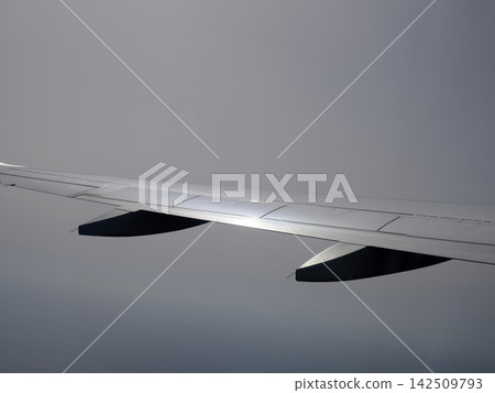 Airplane wing detail while flying Airplane wing detail while flying 142509793