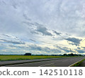 A landscape of fields and roads with clouds spreading across them. 142510118