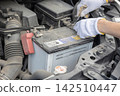 Car battery replacement in progress 142510447