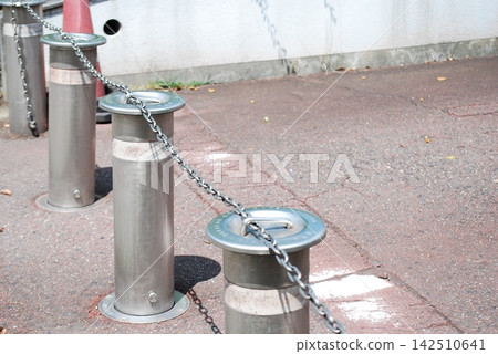 Metal bollards connected by chains Metal bollards connected by chains 142510641