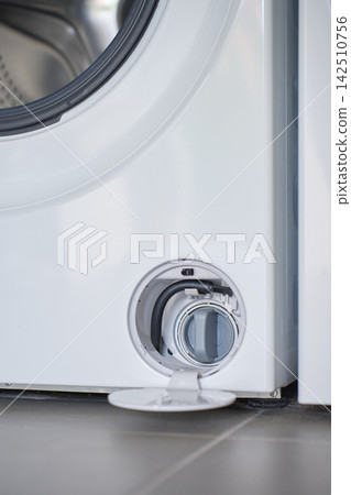 Open drain filter compartment at bottom of front loading washing machine Open drain filter compartment at bottom of front loading washing machine 142510756
