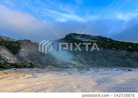 The volcanic smoke from Mount Iwo in Hokkaido in summer, against a blue sky. The volcanic smoke from Mount Iwo in Hokkaido in summer, against a blue sky. 142510878