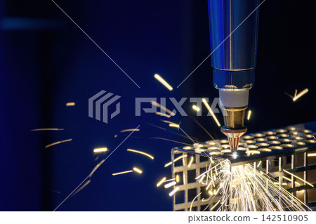 Close up of fiber laser cutting machine engraving a metal square tube with sparkling light Close up of fiber laser cutting machine engraving a metal square tube with sparkling light 142510905