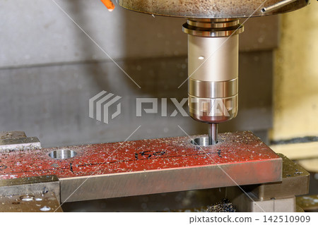 Hole boring on a hard material plate with a flat nose end mill tool on a CNC milling machine Hole boring on a hard material plate with a flat nose end mill tool on a CNC milling machine 142510909