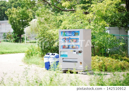 Vending machines and trash cans surrounded by the greenery of the park Vending machines and trash cans surrounded by the greenery of the park 142510912