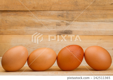 chicken eggs stacked on the wooden table chicken eggs stacked on the wooden table 142511365