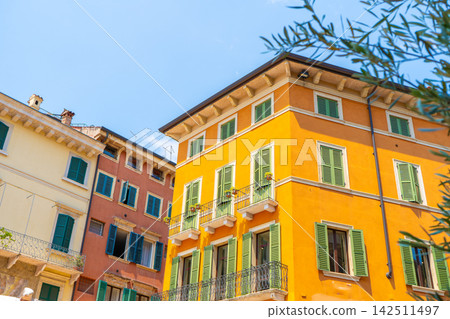Colorful Historic Italian Buildings Facades with Wooden Window Shutters and Balconies in Verona City Colorful Historic Italian Buildings Facades with Wooden Window Shutters and Balconies in Verona City 142511497