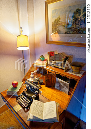 Vintage Writer Desk with Antique Typewriter and Open Book Vintage Writer Desk with Antique Typewriter and Open Book 142512360
