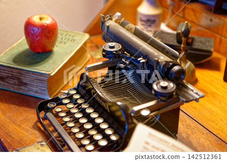 Vintage Writer Desk with Antique Typewriter and Open Book Vintage Writer Desk with Antique Typewriter and Open Book 142512361