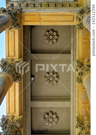 Low Angle View of Classical Corinthian Columns and Coffered Ceiling Portico Low Angle View of Classical Corinthian Columns and Coffered Ceiling Portico 142512394