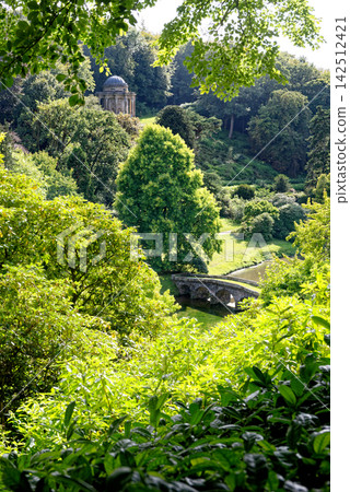 Scenic Panoramic Vista Over the Lush Valley Gardens of Stourhead Estate Scenic Panoramic Vista Over the Lush Valley Gardens of Stourhead Estate 142512421
