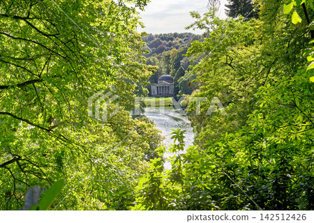 Classical Temple of Flora Framed by Lush Summer Foliage Over Lake Stourhead Classical Temple of Flora Framed by Lush Summer Foliage Over Lake Stourhead 142512426