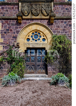 Gothic Revival Entrance and Ornate Stone Archway at Knightshayes Court Gothic Revival Entrance and Ornate Stone Archway at Knightshayes Court 142512537