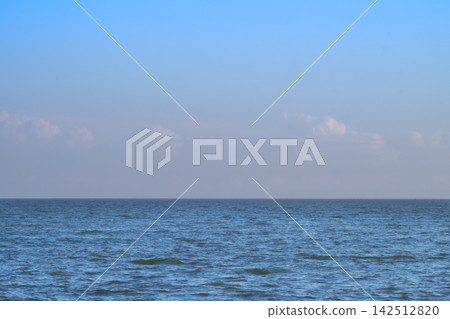 Blue Sea Ocean under blue sky with fluffy white cloud seascape nature background summer travel vacation 142512820