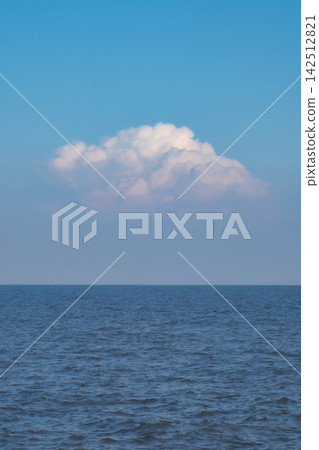 Blue Sea Ocean under blue sky with fluffy white cloud seascape nature background summer travel vacation vertical image Blue Sea Ocean under blue sky with fluffy white cloud seascape nature background summer travel vacation vertical image 142512821