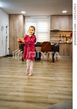 Little Girl Dancing at Home in the Kitchen Little Girl Dancing at Home in the Kitchen 142512913