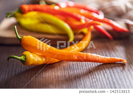Colorful Hot Chili Peppers on Wooden Table for Cooking, Spices and Fresh Produce Colorful Hot Chili Peppers on Wooden Table for Cooking, Spices and Fresh Produce 142513815