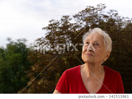 Portrait of old senior woman at balcony 142513861