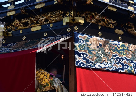 A boy participating in the Inuyama Spring Festival in Inuyama City, Aichi Prefecture, Japan, is seen riding on a float, wearing a gold undergarment, and beating a small drum. A boy participating in the Inuyama Spring Festival in Inuyama City, Aichi Prefecture, Japan, is seen riding on a float, wearing a gold undergarment, and beating a small drum. 142514425