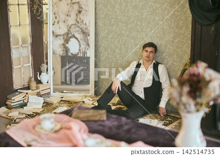 Distinguished male author in stylish historic bedroom scene Distinguished male author in stylish historic bedroom scene 142514735