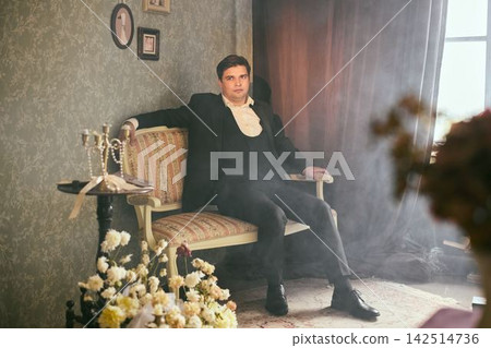 Stylish vintage portrait capturing actor in ornate setting with warm tones 142514736