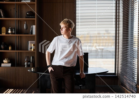 White male at desk with laptop enjoying calm work setting White male at desk with laptop enjoying calm work setting 142514740