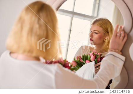 Fashion professional evaluates wedding gown details carefully Fashion professional evaluates wedding gown details carefully 142514756