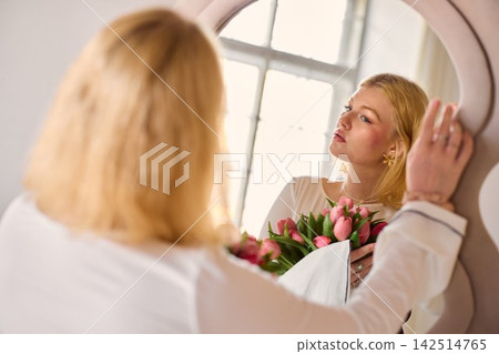 Closeup of woman gently touching cheek with skincare focus Closeup of woman gently touching cheek with skincare focus 142514765