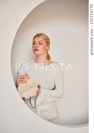 Peaceful studio shot featuring woman and knitting materials Peaceful studio shot featuring woman and knitting materials 142514770
