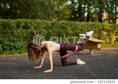 White woman yoga instructor teaching hip mobility kickback 142514826