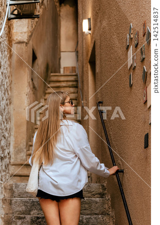 Local European Woman Walking up Stone Stairs Local European Woman Walking up Stone Stairs 142514837