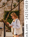 Local European Woman Reading Restaurant Menu 142514839