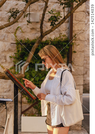 Local European Woman Reading Restaurant Menu Local European Woman Reading Restaurant Menu 142514839