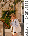 Local Woman Thinking while Reading Restaurant Menu 142514841
