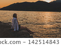 Woman Sitting on Pier Watching Sea Sunset 142514843