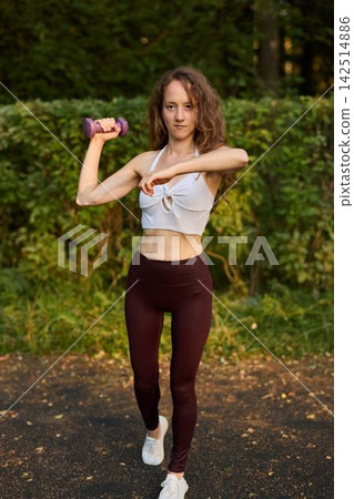 Caucasian woman demonstrating punch technique with dumbbell 142514886