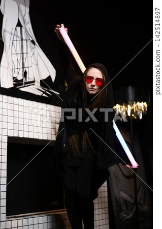 Casual Party Attendee with Fluorescent Accessories in Nightclub Casual Party Attendee with Fluorescent Accessories in Nightclub 142514897