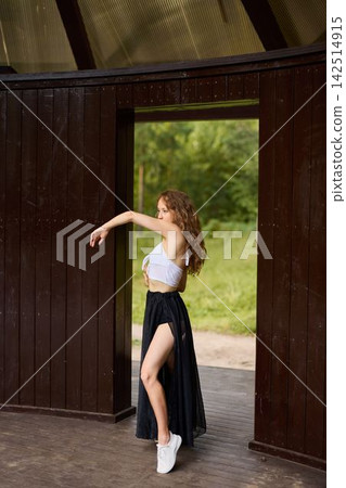 Choreographer practicing solo in peaceful woodland setting with sunlight Choreographer practicing solo in peaceful woodland setting with sunlight 142514915