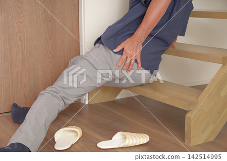 A senior man injured his lower back after falling down the stairs. A senior man injured his lower back after falling down the stairs. 142514995