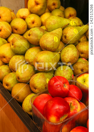 Fresh pears and apples filling market display, promoting healthy eating, nutrition, and organic food choices Fresh pears and apples filling market display, promoting healthy eating, nutrition, and organic food choices 142515266