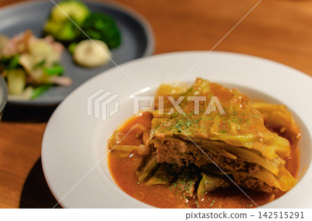 Cabbage rolls simmered in tomato sauce. A menu photo from a Western-style restaurant. Cabbage rolls simmered in tomato sauce. A menu photo from a Western-style restaurant. 142515291