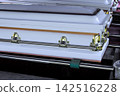 Coffins are arranged in funeral home during preparation for memorial service. 142516228
