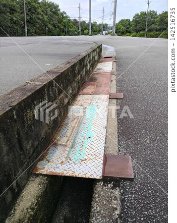Drainage ditch at the side of the road Drainage ditch at the side of the road 142516735
