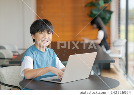 Boy taking online classes Boy taking online classes 142516994